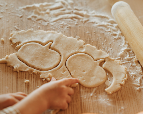 toddlers making cookies shaped like pumpkins